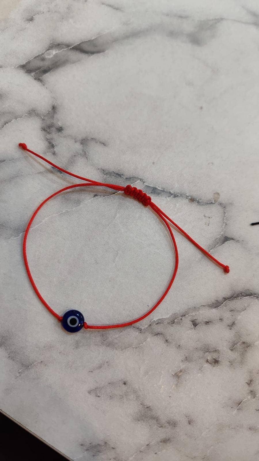 Evil eye wish bracelet with red cord from Evileyefavor