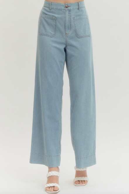 Denim wide leg pants featuring front patch pockets and stitched waistband