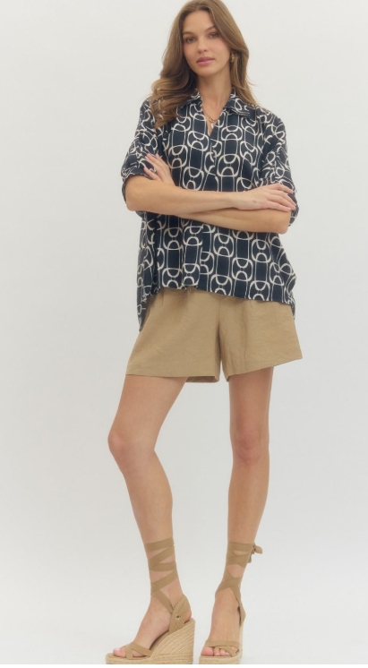 NAVY. Geometric print short sleeve top featuring open stand collar and front button