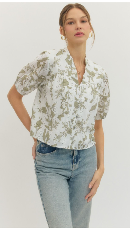 Floral eyelet puff sleeve top featuring V-neck yoke and front button closure.