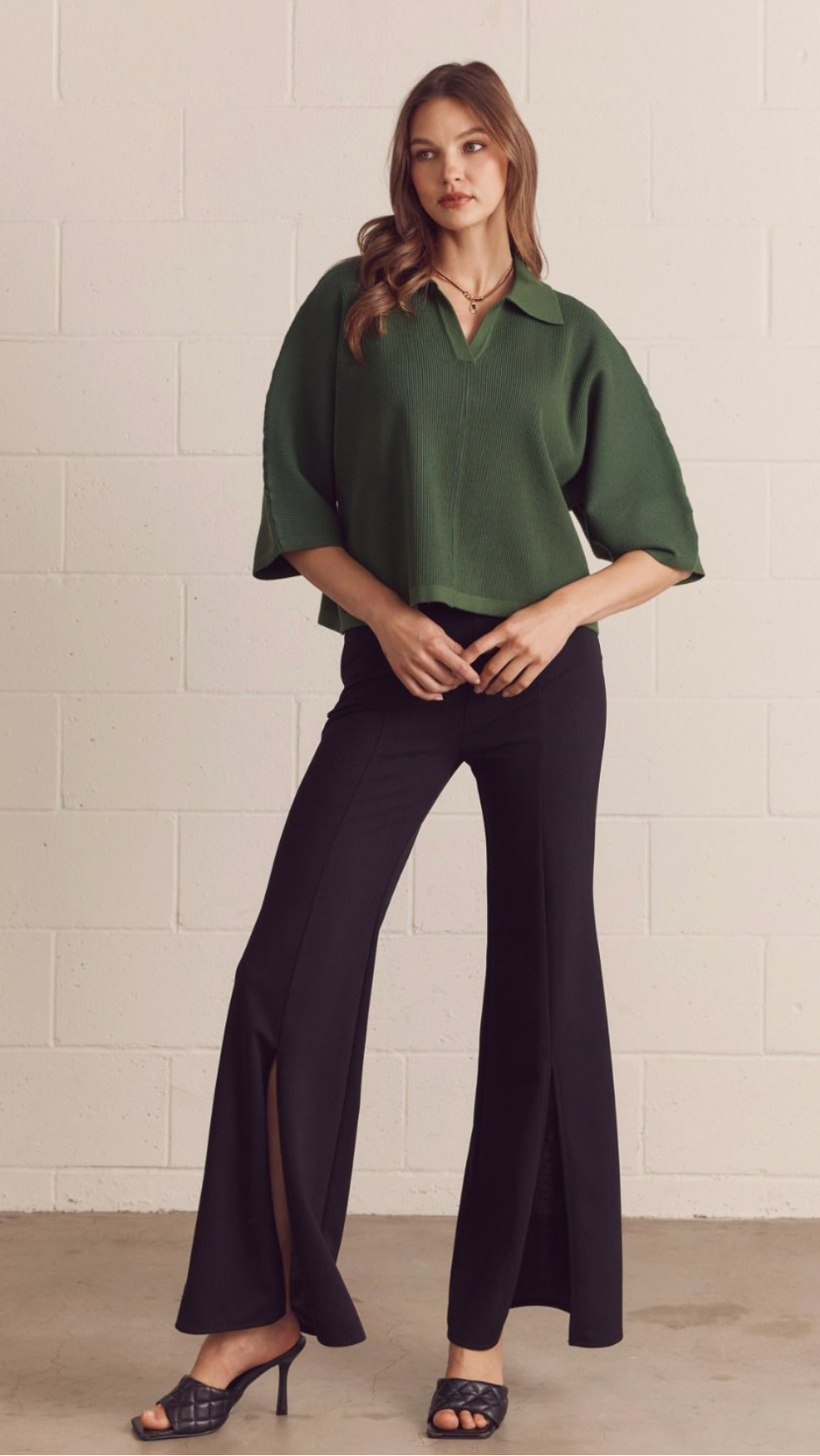 Solid 3/4 sleeve knit top featuring open V-neck collar. Unlined. Knit. Non-sheer. Medium weight.