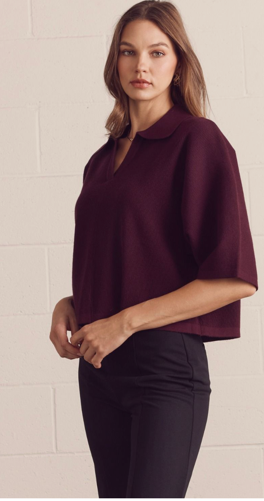 Solid 3/4 sleeve knit top featuring open V-neck collar. Unlined. Knit. Non-sheer. Medium weight.