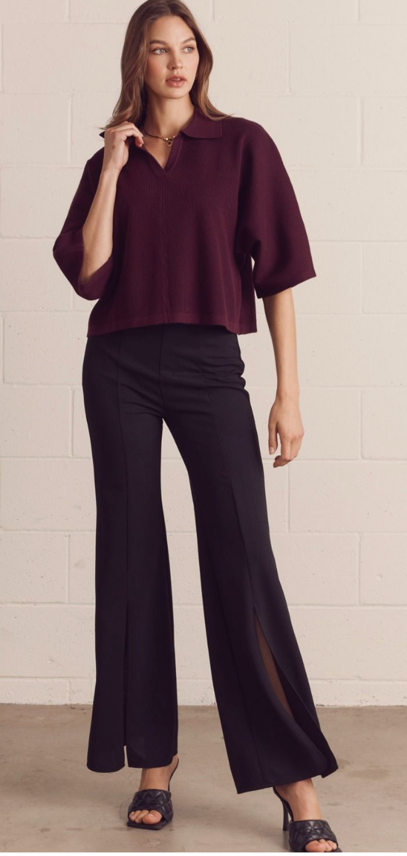 Solid 3/4 sleeve knit top featuring open V-neck collar. Unlined. Knit. Non-sheer. Medium weight.