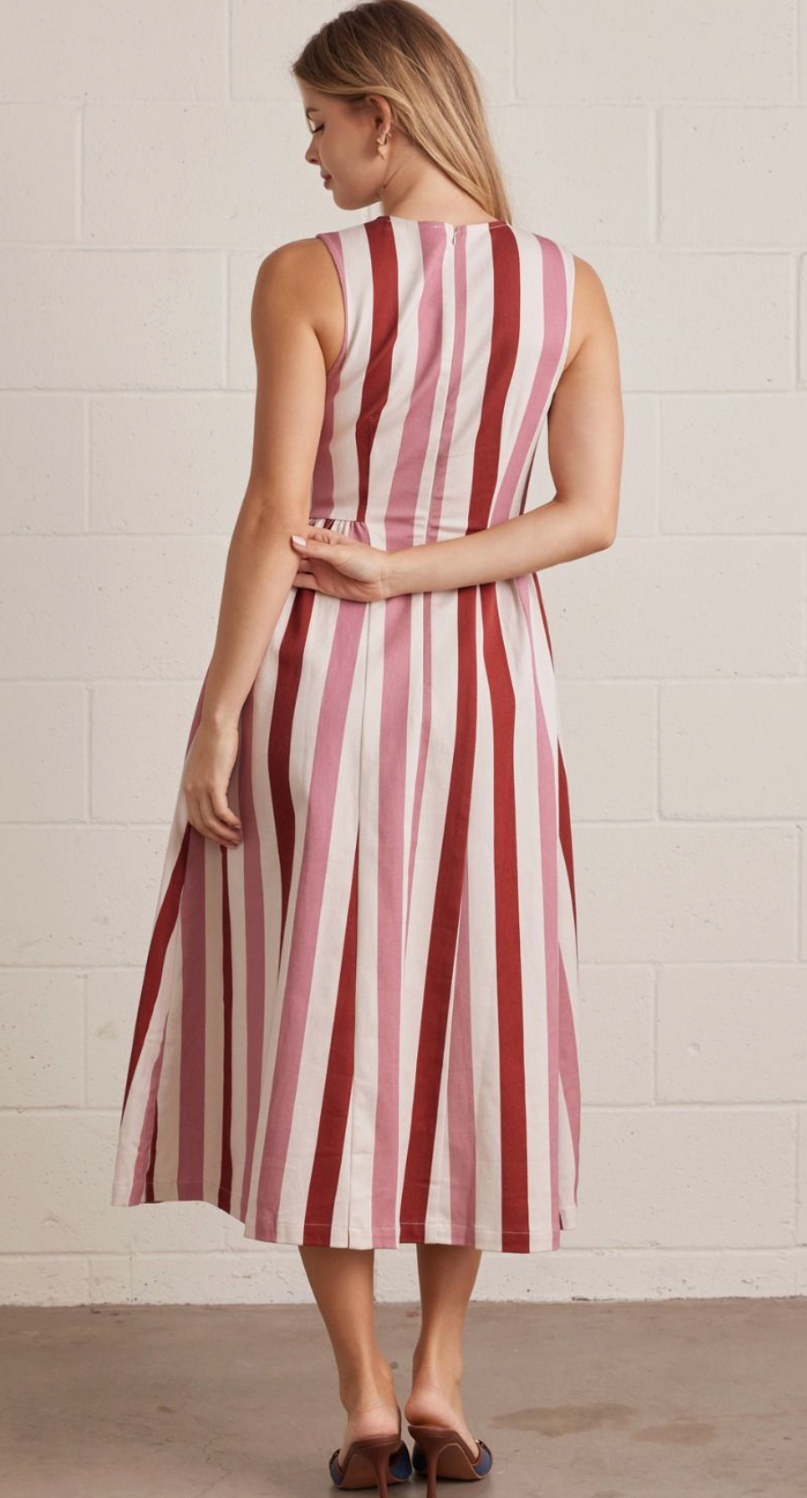 Rustic Combo striped sleeveless midi dress featuring back zipper closure. Side pockets. Unlined. Woven. Non-sheer. Lightweight.