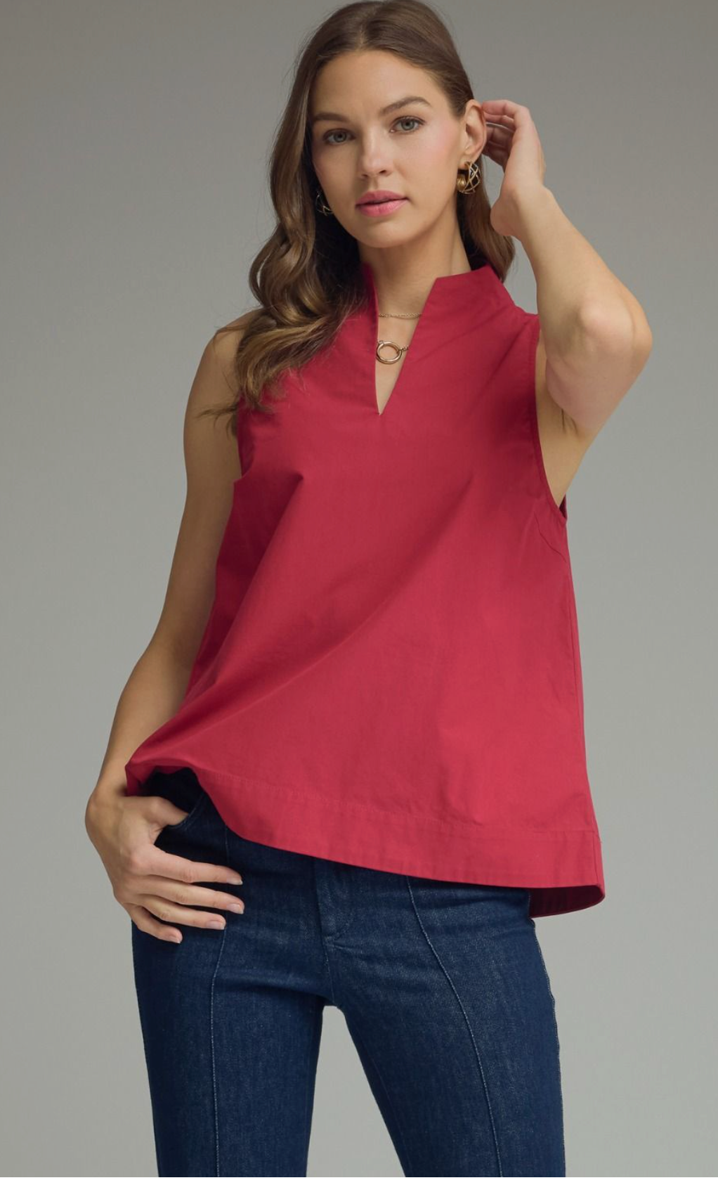 Solid sleeveless top featuring split V-neck with stand collar. Unlined. Woven. Non-sheer. Lightweight.