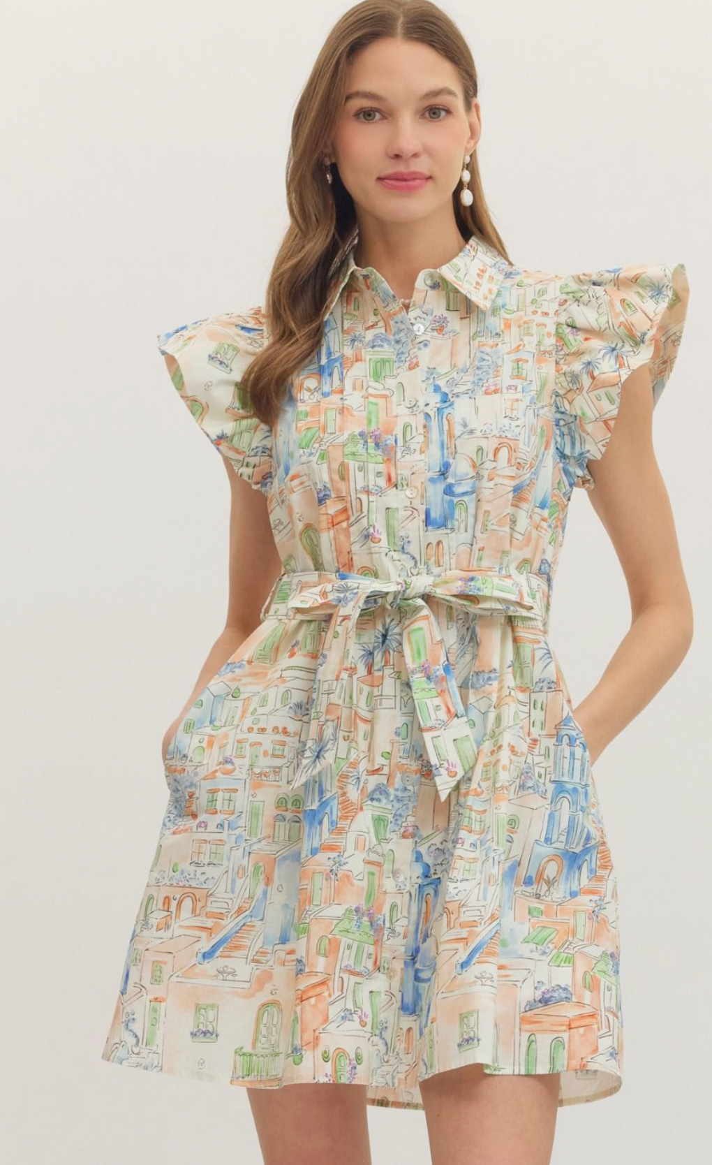 Illustrated novelty print flutter sleeve mini dress featuring waist tie detail. Button closure at front. Side pockets. Lined. Woven. Non-sheer. Lightweight.