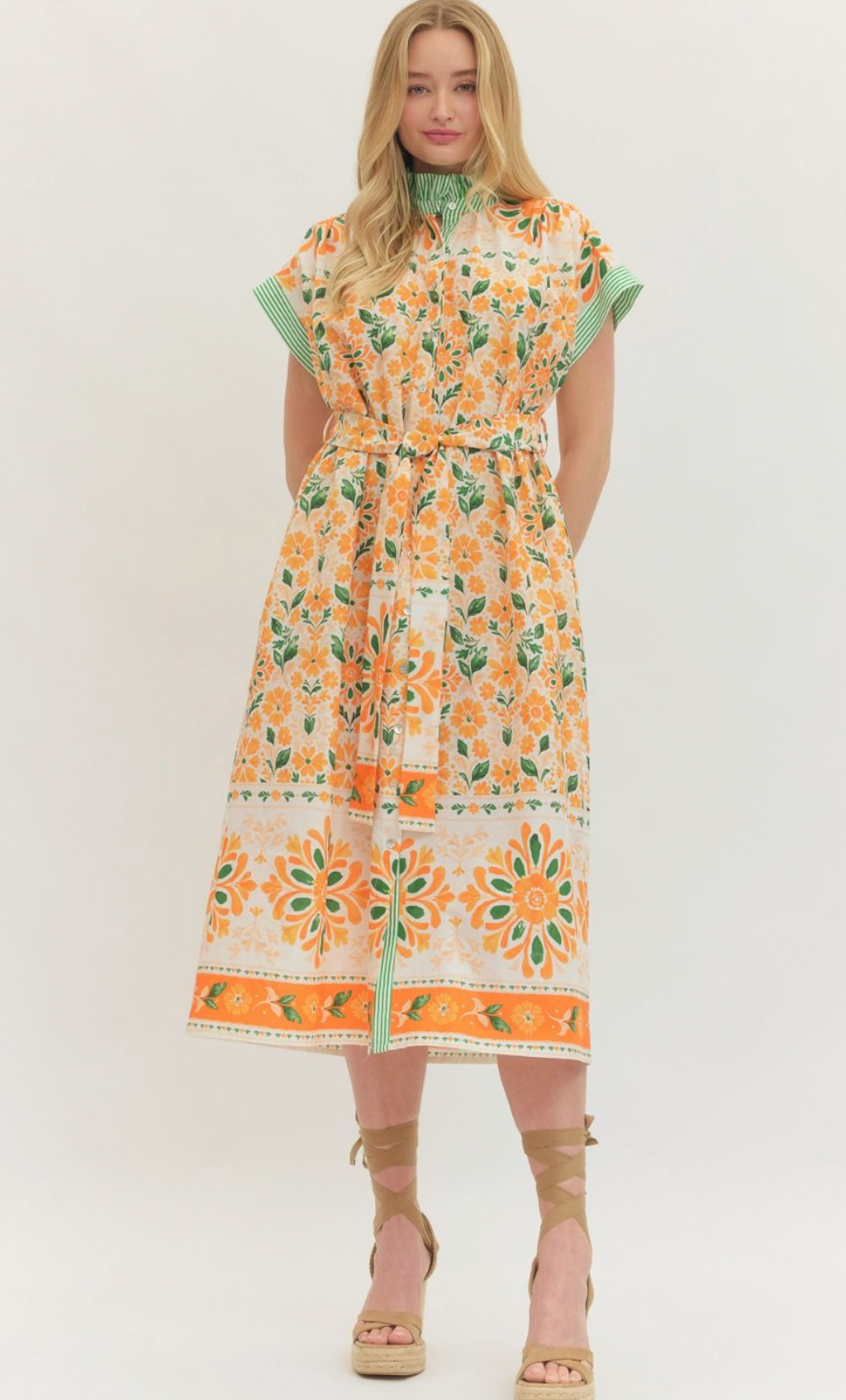 Floral print short flutter sleeve midi dress featuring self-tie belt at waist. Button closure at front. Contrast trim at stand collar and sleeve hems. Pocket at sides. Lined. Woven. Non-sheer. Lightweight.