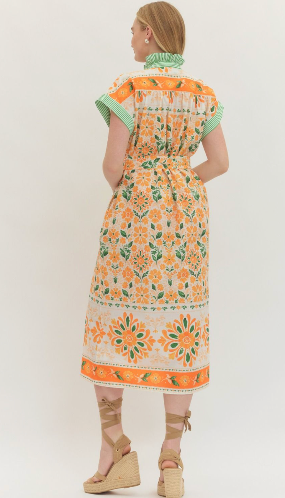 Floral print short flutter sleeve midi dress featuring self-tie belt at waist. Button closure at front. Contrast trim at stand collar and sleeve hems. Pocket at sides. Lined. Woven. Non-sheer. Lightweight.