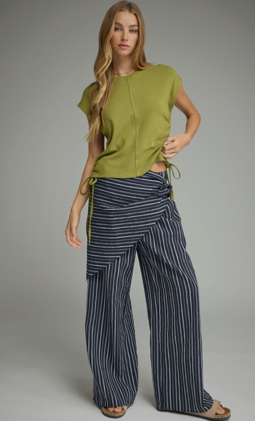Solid knit cap sleeve top featuring side drawstring ties.