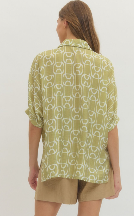 MATCHA. Geometric print short sleeve top featuring open stand collar and front button closure.
